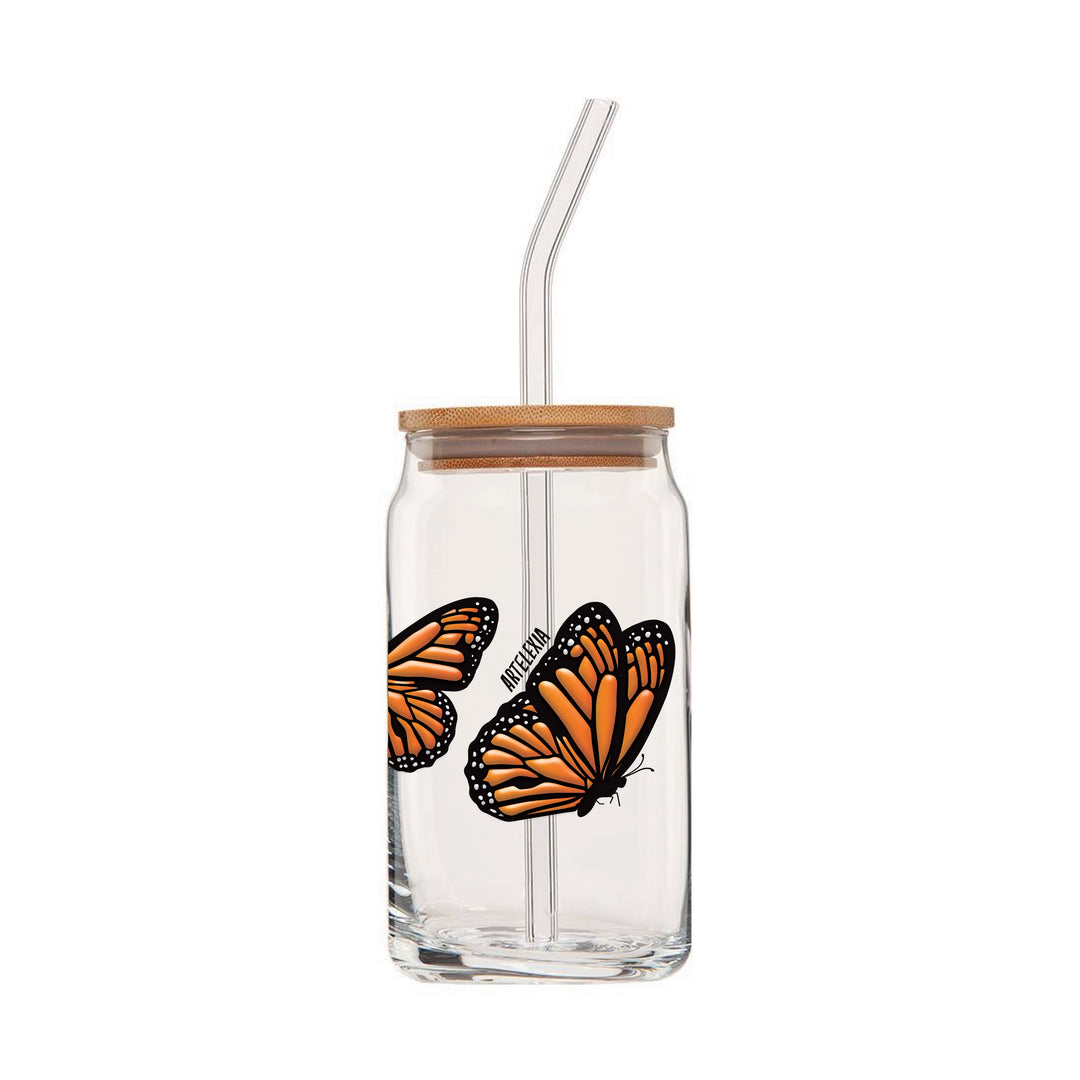 Clear can glass with an embossed wrap around design featuring four monarch butterflies & wooden lid and glass straw.