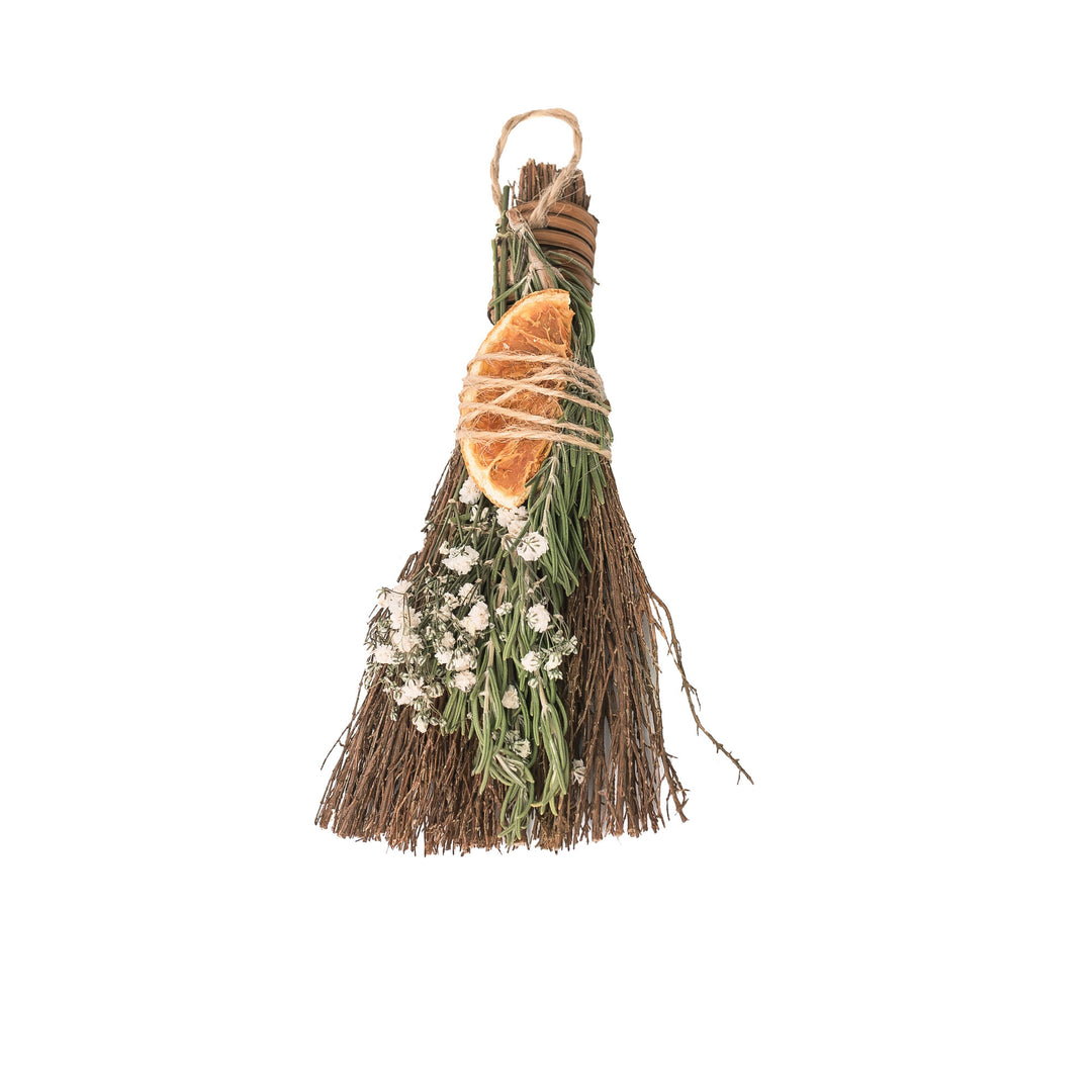Broom with a stick of cinnamon, orange slice, baby breath and rosemary. 
