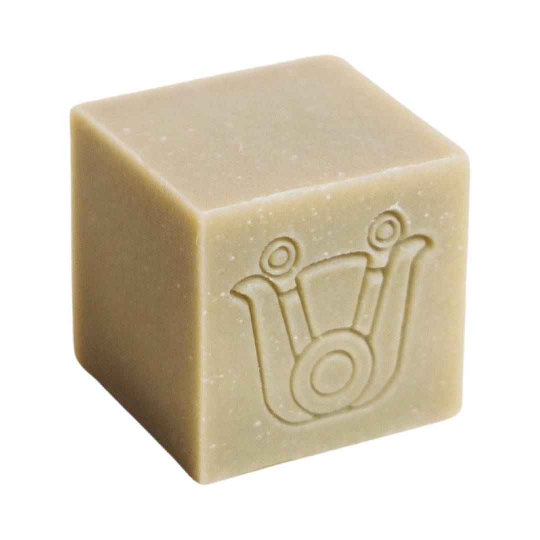 light gray colored cube shaped soap with an icon design. Brand: Paca Botánica