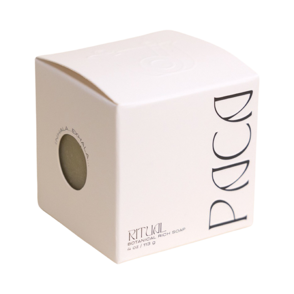 white branded cube shaped box with black lettering. Brand: Paca Botánica