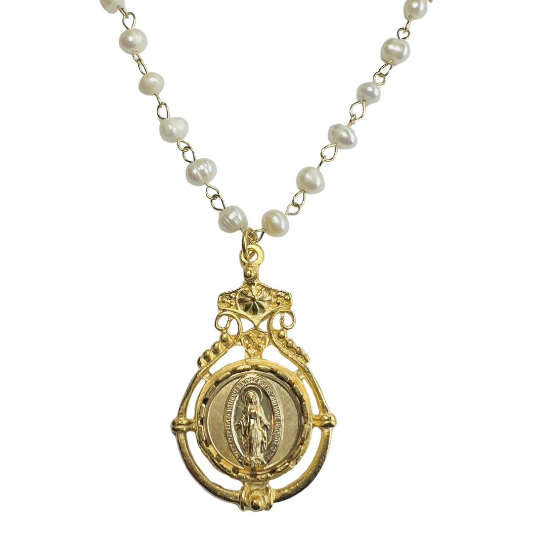 pearl necklace with an ornate medallion of the Virgin Mary