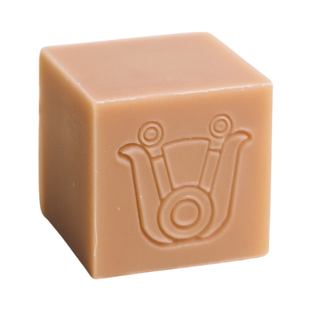 peach colored cube shaped soap with an icon design. Brand: Paca Botánica