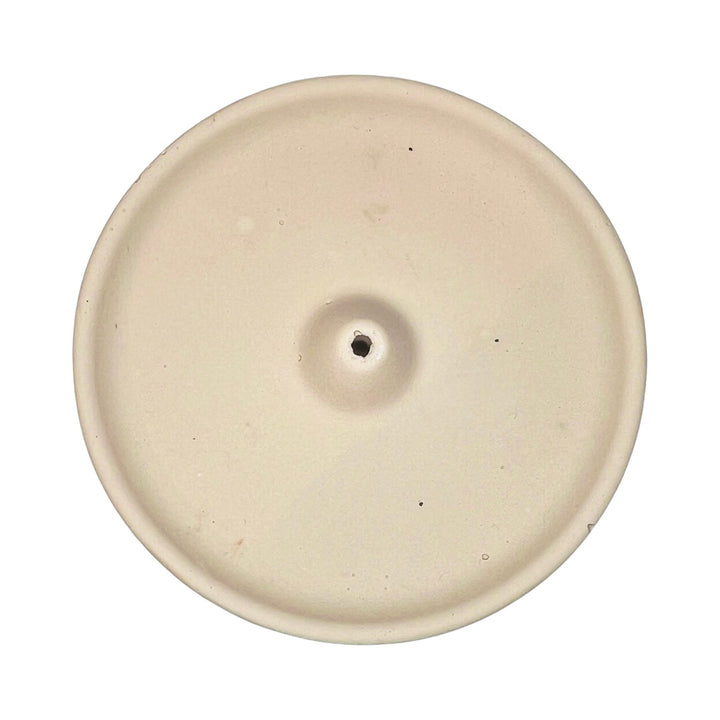 top view of a round blush colored incense holder