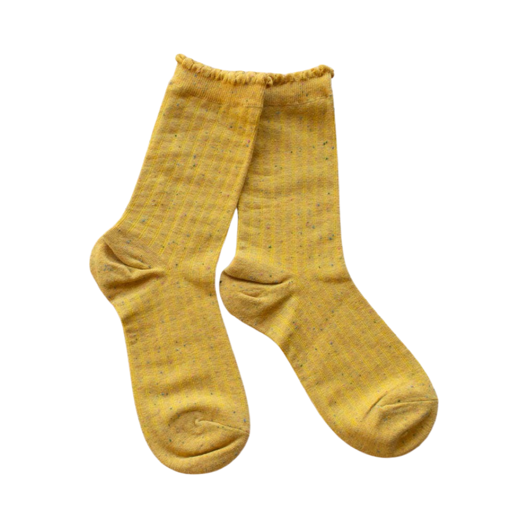 mustard colored pair of socks with multi-colored speckles