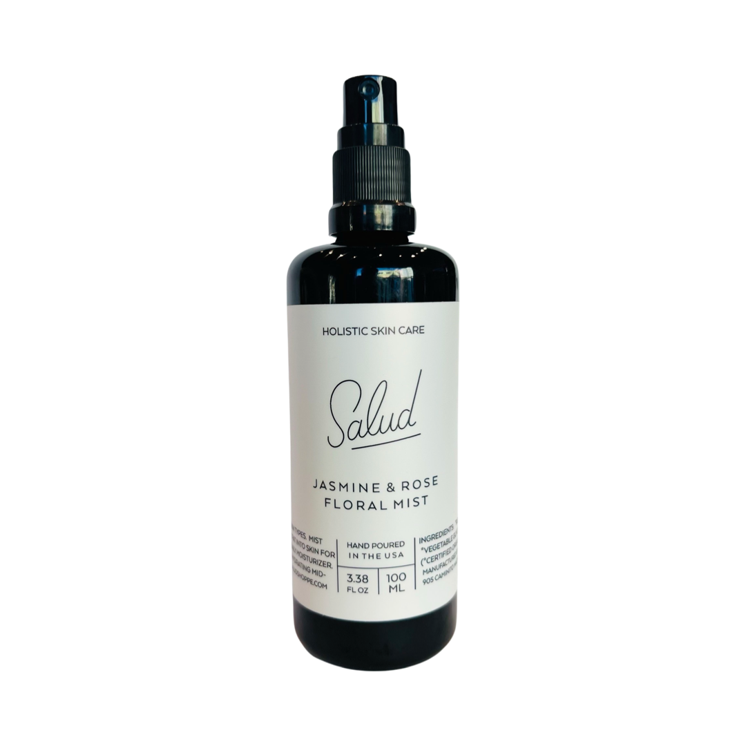 3.38 oz dark brown glass bottle of Salud Jasmine and Rose Floral Mist with a white branded label. Brand: Salud