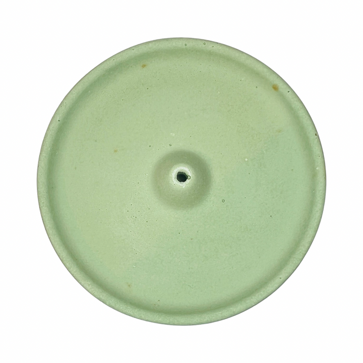 top view of a round sage colored incense holder