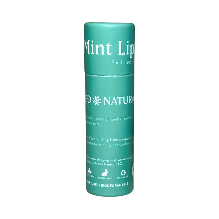 SIngle tube of lip balm with green branded label and white lettering. Brand: UnTamed Naturals