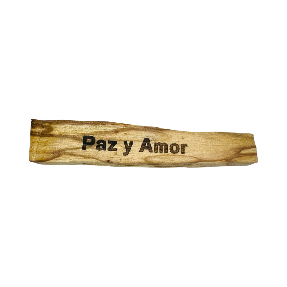 palo santo stick engraved with the phrase Paz y Amor (peace and love)