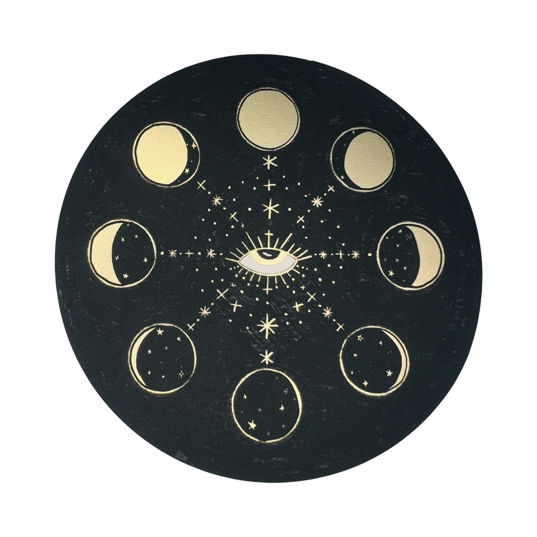 black round sticker that features illustrations of the moon's phases in gold with a gold eye in the center