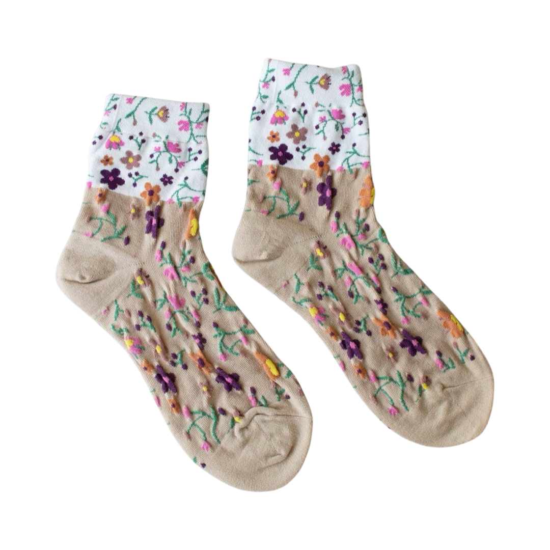 ivory and taupe two toned pair of socks with a multi-colored floral design