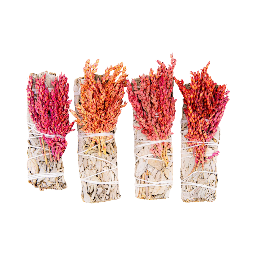 four sage bundles with red celosia flowers tied with white twine