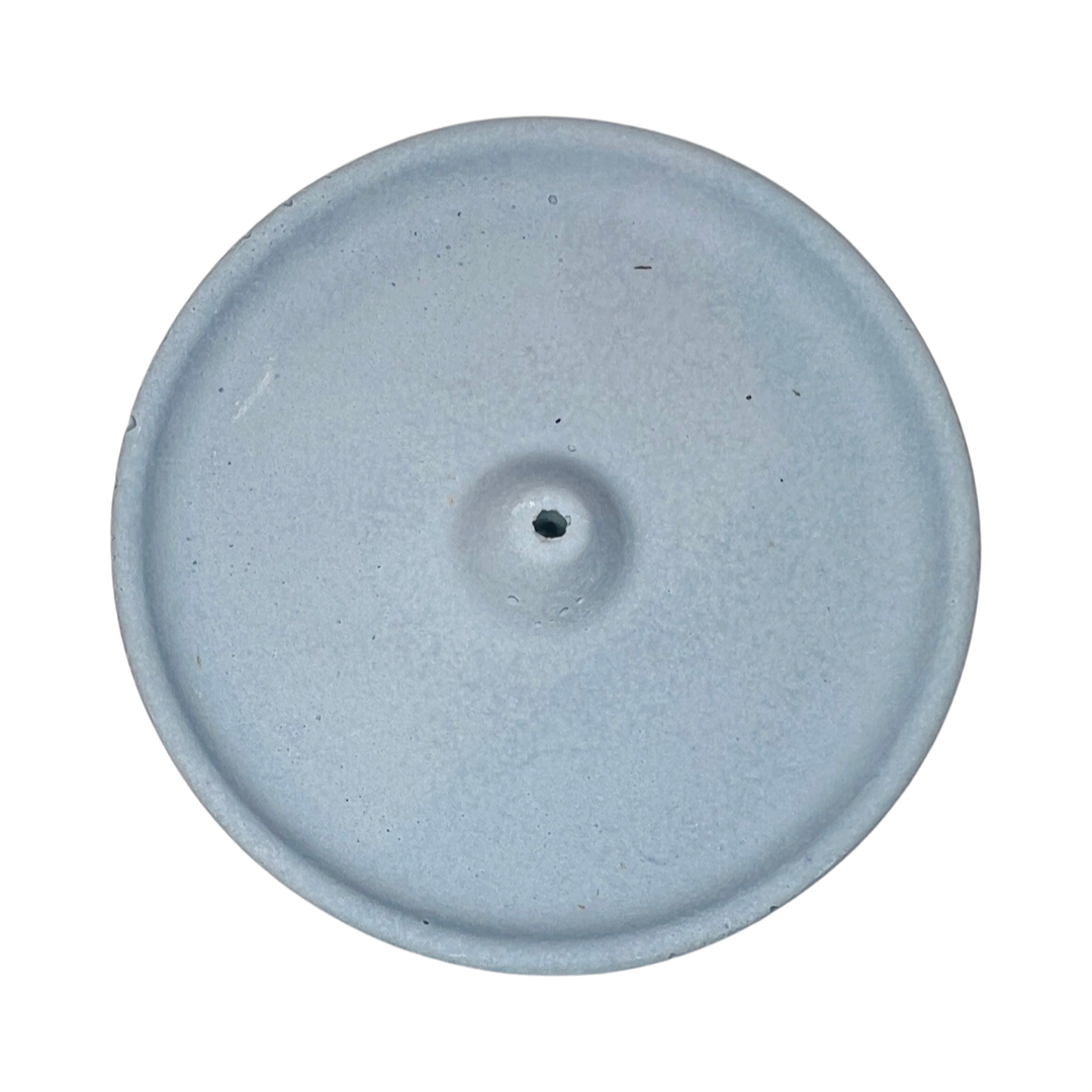 top view of a round dusty blue colored incense holder