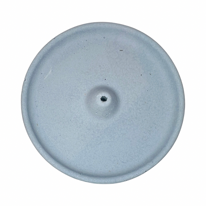 top view of a round dusty blue colored incense holder