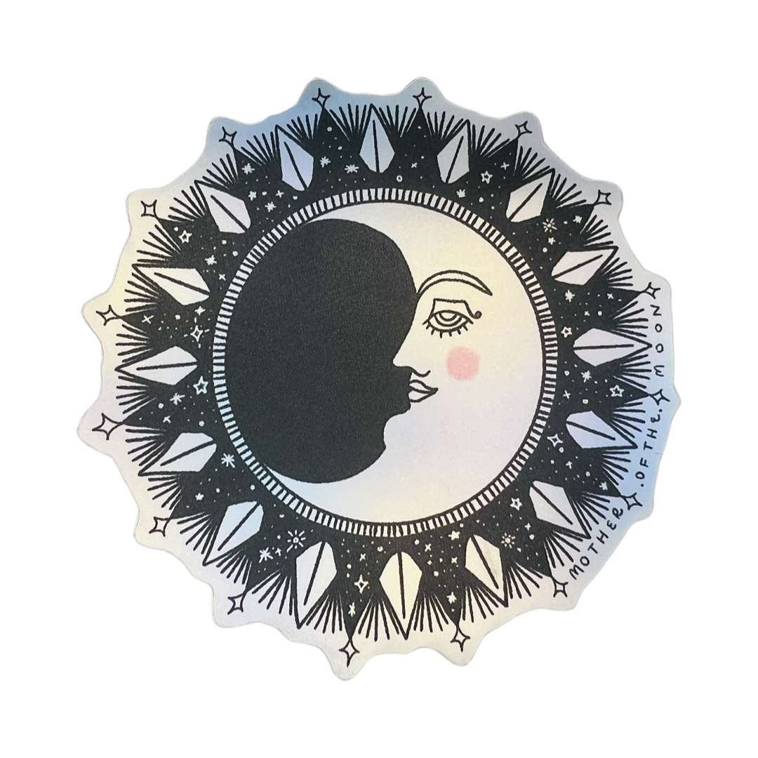 holographic sticker of a crescent moon with a diamond design encircling it