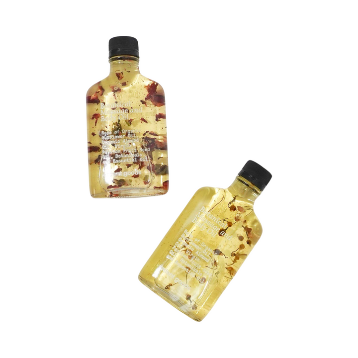 two bottles of oil with dried flowers. Brand: Ardent Goods