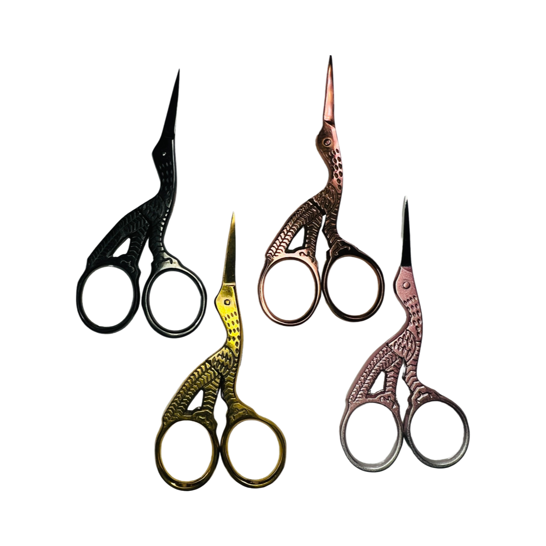 4 stork shaped scissors in the following colors: black, gold, copper and pink