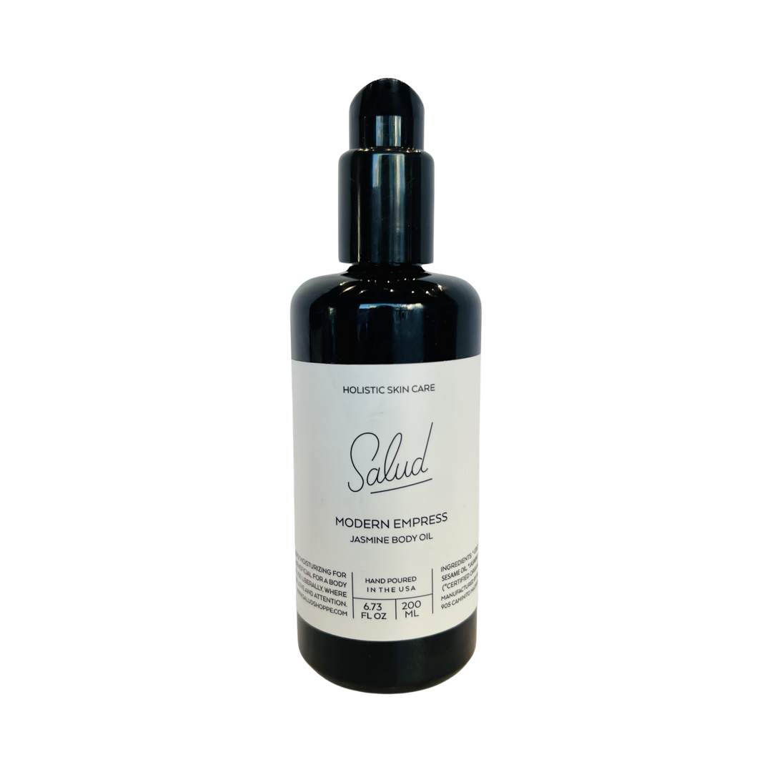 6.73 oz dark brown glass bottle of Salud Modern Empress Jasmine Body Oil with a white branded label. Brand: Salud