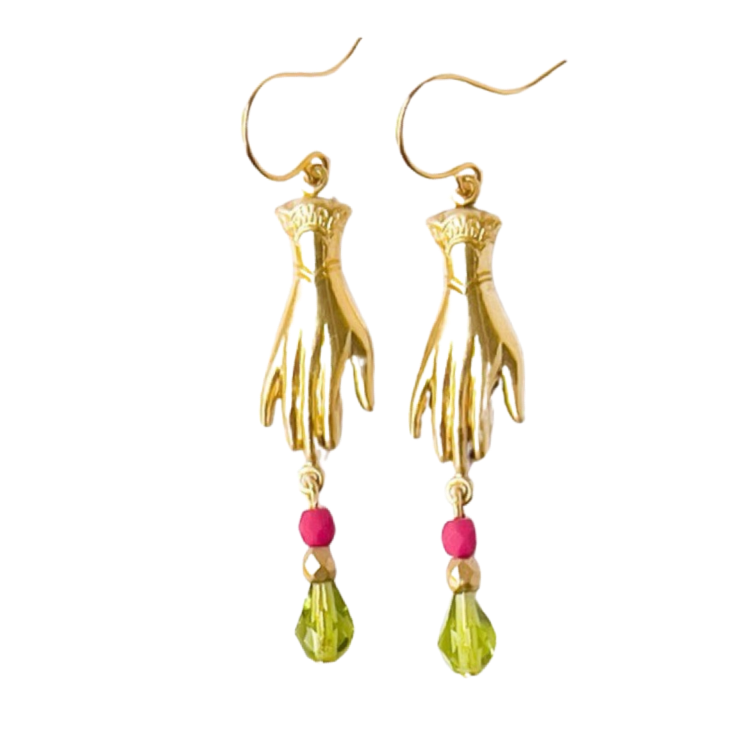 close up of a set of earrings that feature a brass hand and 3 multi-colored Czech glass beads