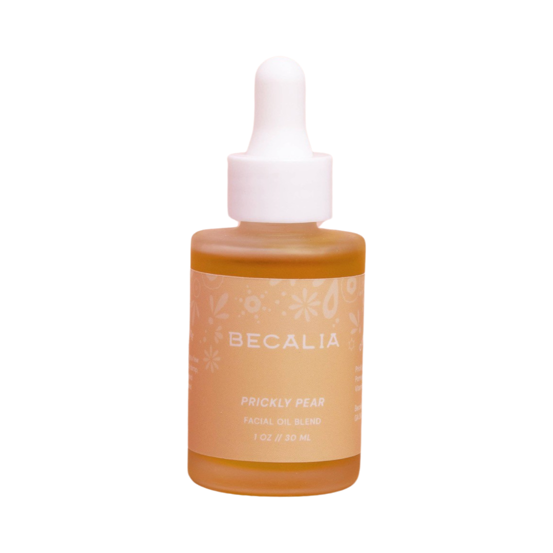 frosted 1 oz dropper jar of prickly pear facial oil with a peach branded label and a white dropper. Brand: Becalia Botanicals
