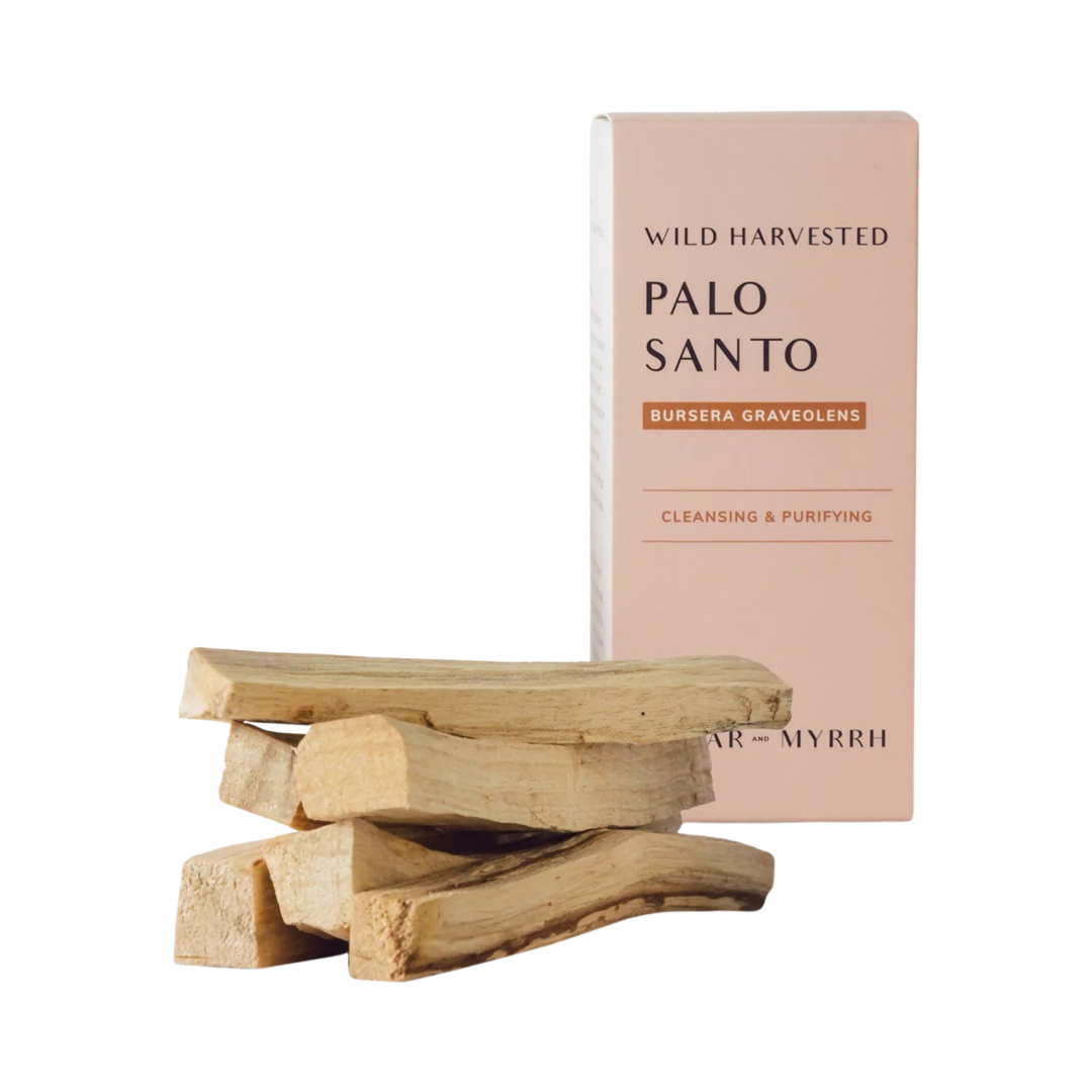 stack of palo santo sticks with a light pink box of the sticks in the background. Brand: Cedar and Myrrh