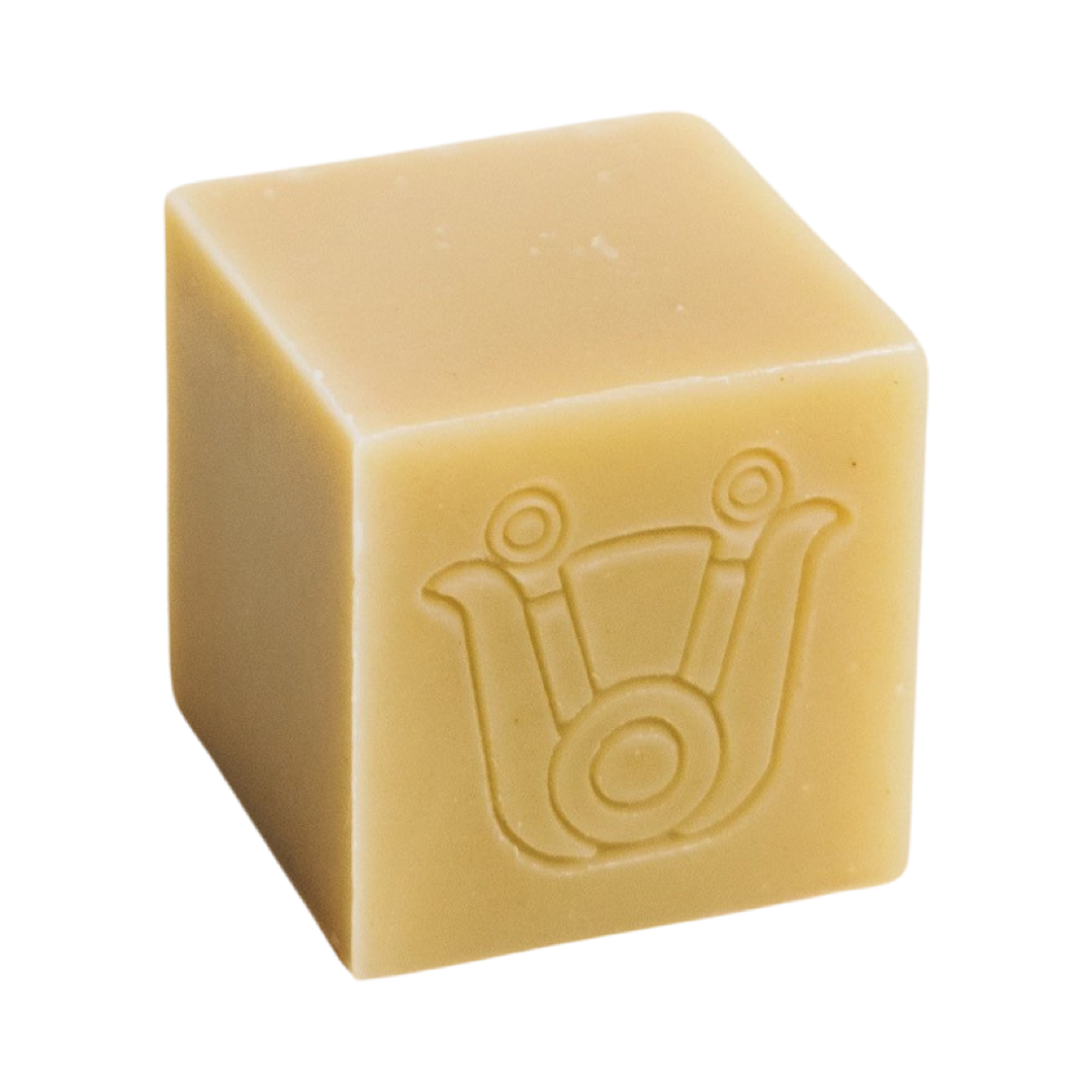 pale yellow colored cube shaped soap with an icon design. Brand: Paca Botánica