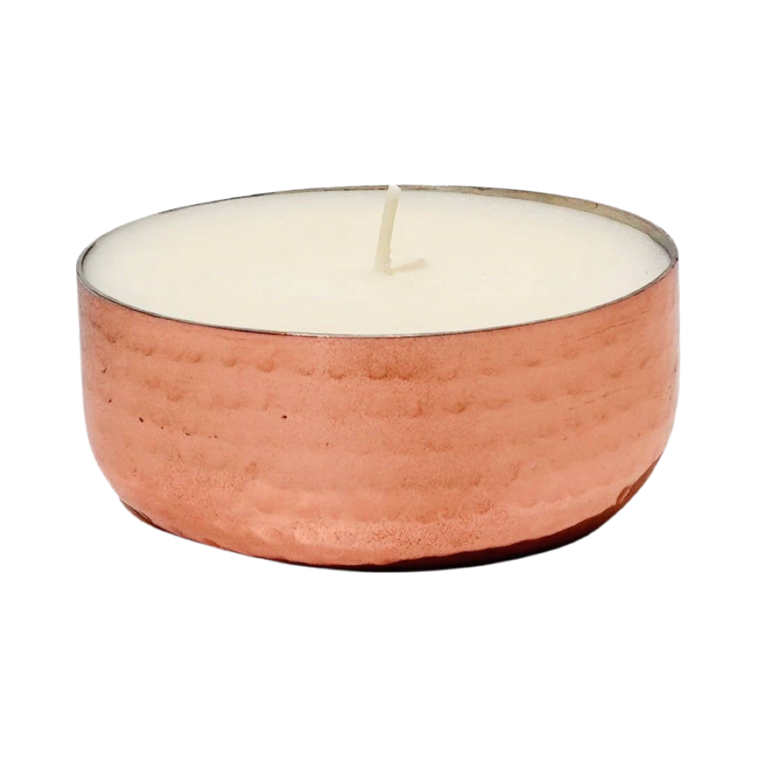 white candle in a copper vessel. Brand: Ardent Goods