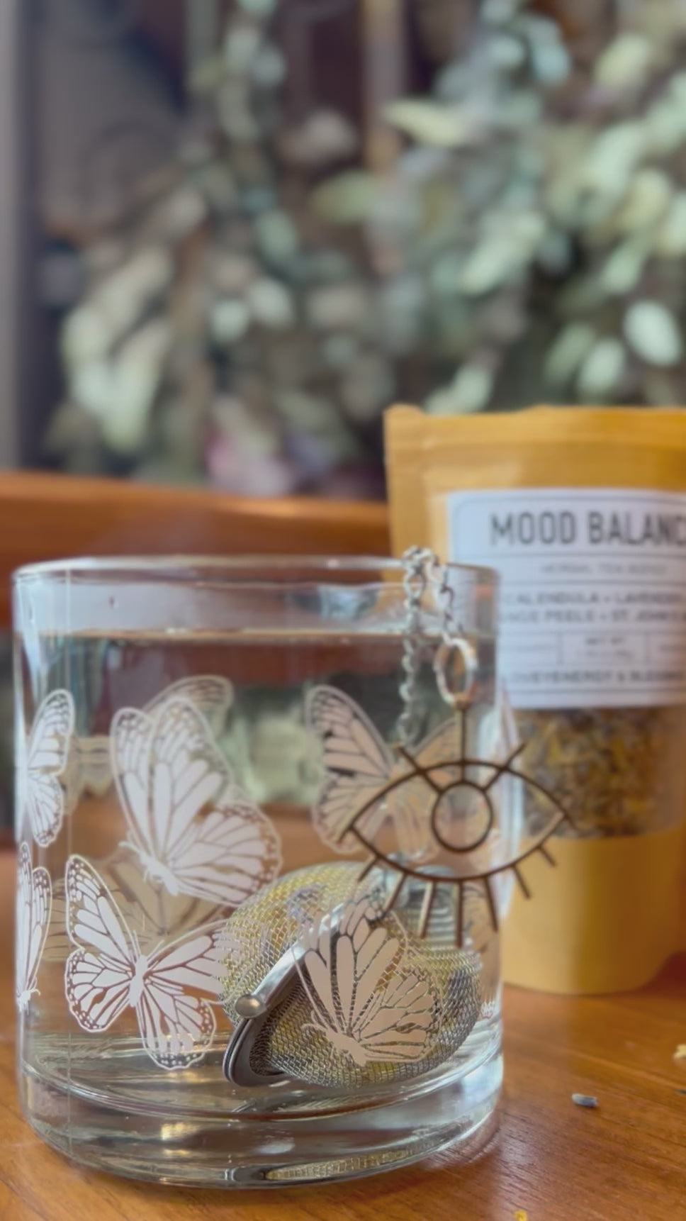 video of stainless steel round tea infuser with a gold eye charm