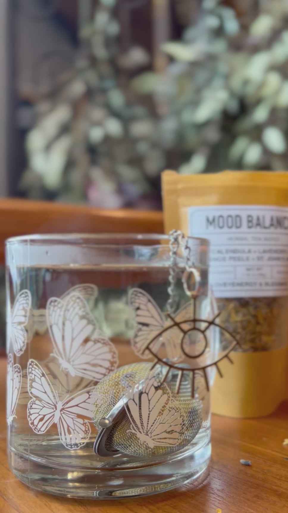 Video of clear glass mug featuring a wraparound design of ivory colored monarch butterflies
