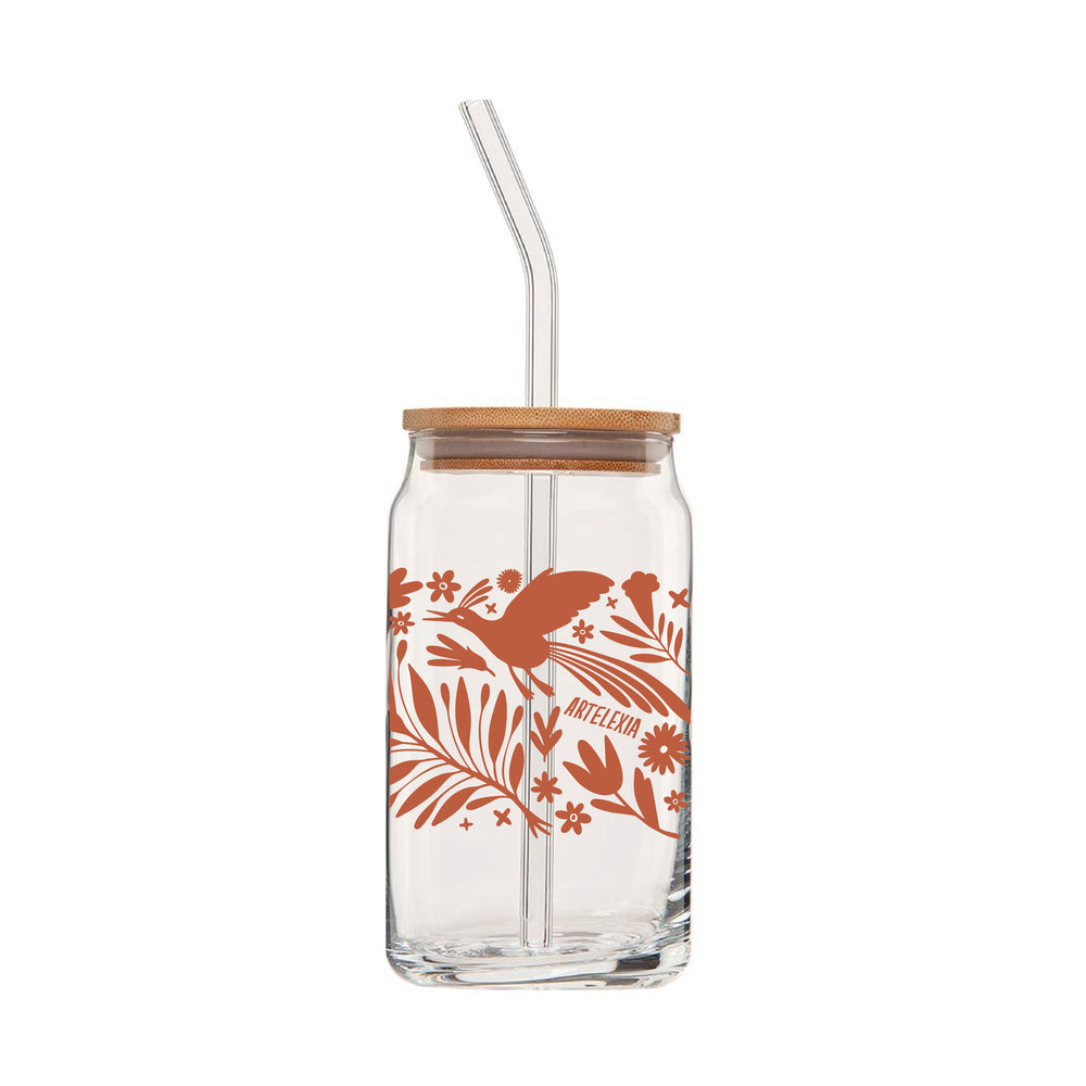 Back view of clear can glass featuring a wraparound print of a terra cotta colored otomi design. This glass also comes with a bamboo lid & a clear glass drinking straw.