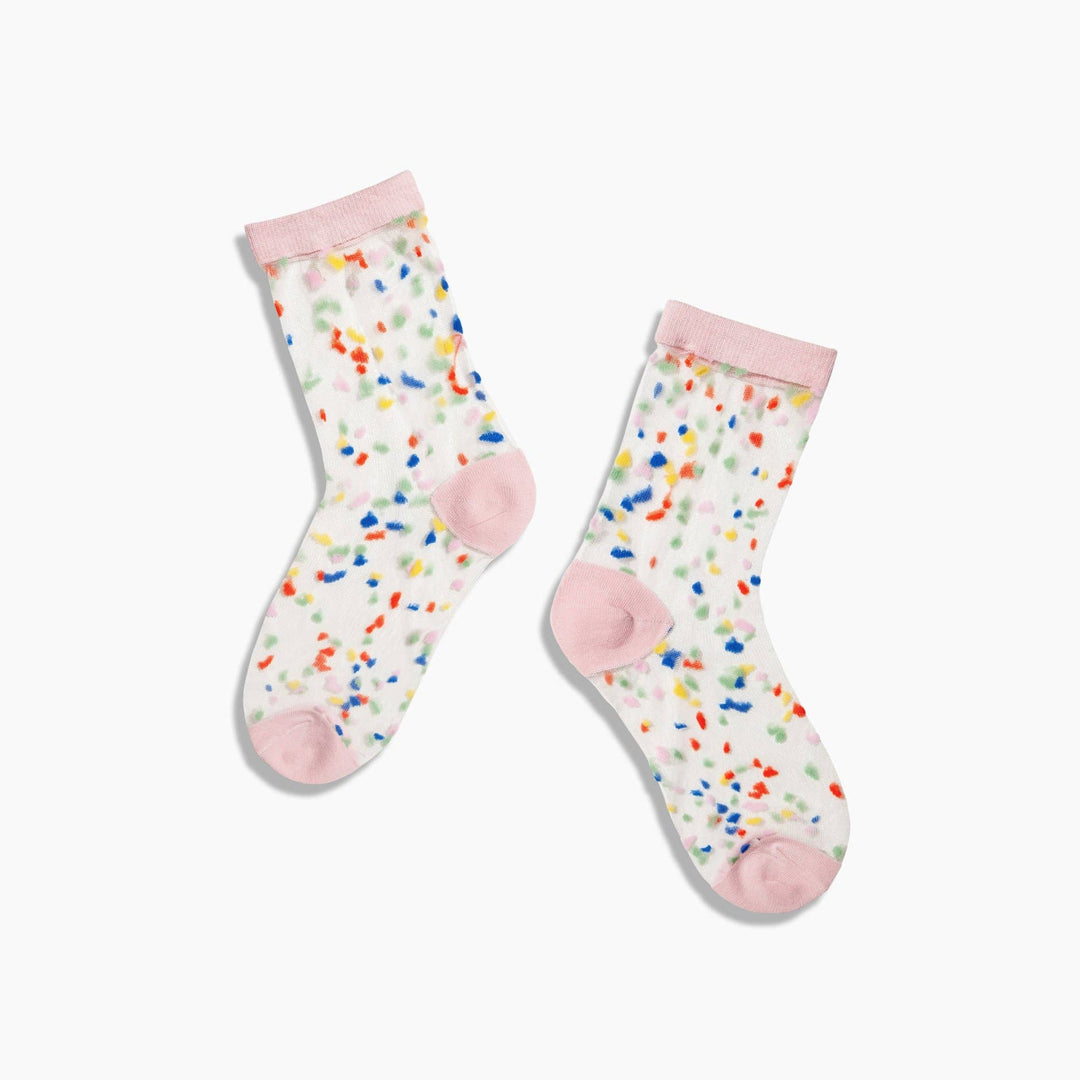 A pair of sheer socks with a happy confetti pattern and pink detail