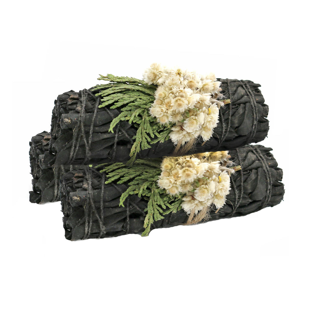 3 bundles of black colored sage with white flowers.