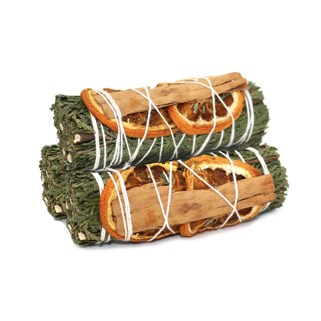 3 bundles of rosemary with slices of oranges and cinnamon sticks wrapped in white twine