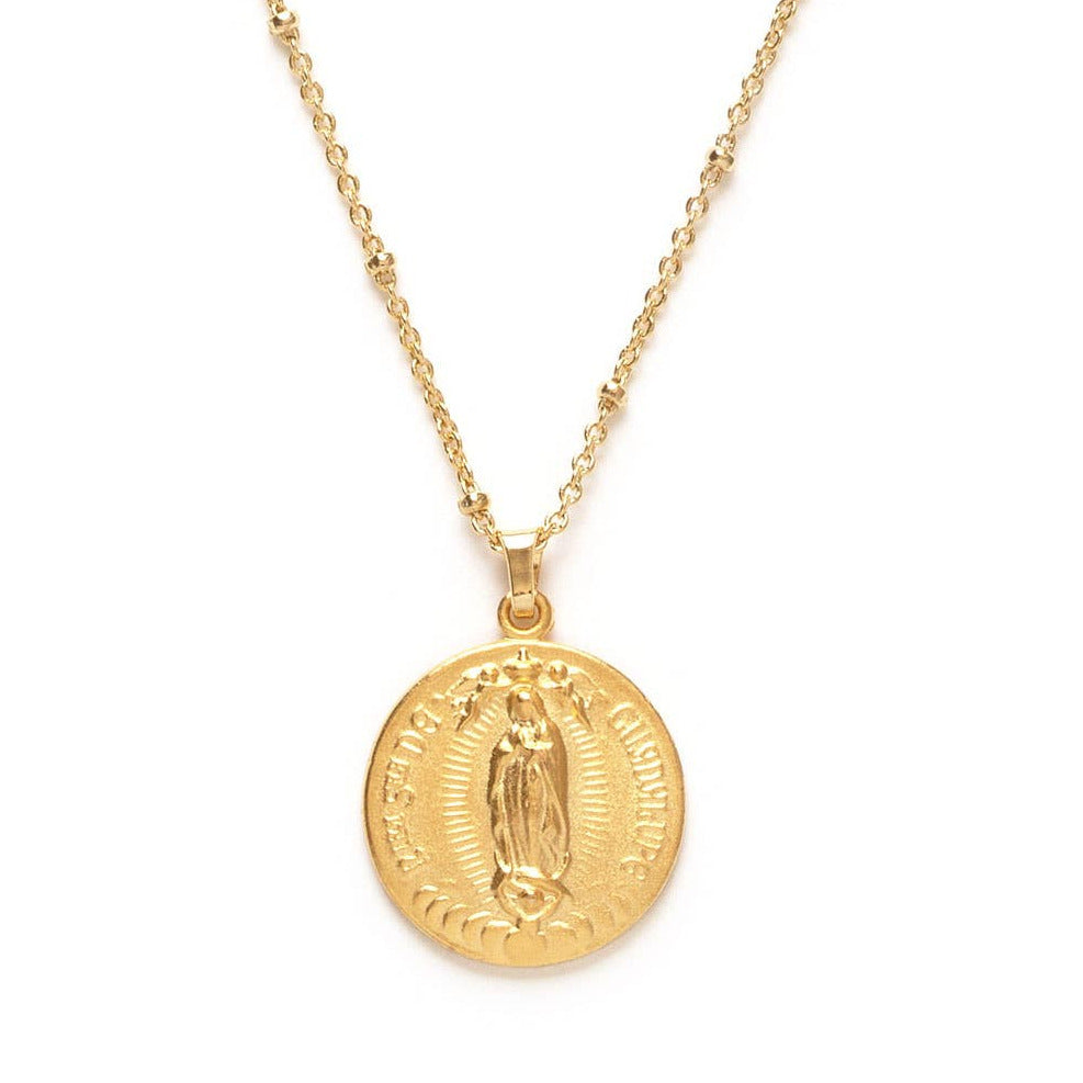 close up of a gold round virgen mary medallion on a gold chain. Brand: Amano Studio