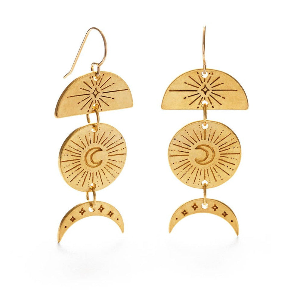 set of gold earrings that feature a crescent moon, a round pendant with a cresent moon and a half circle with a star burst. Brand: Amano Studio