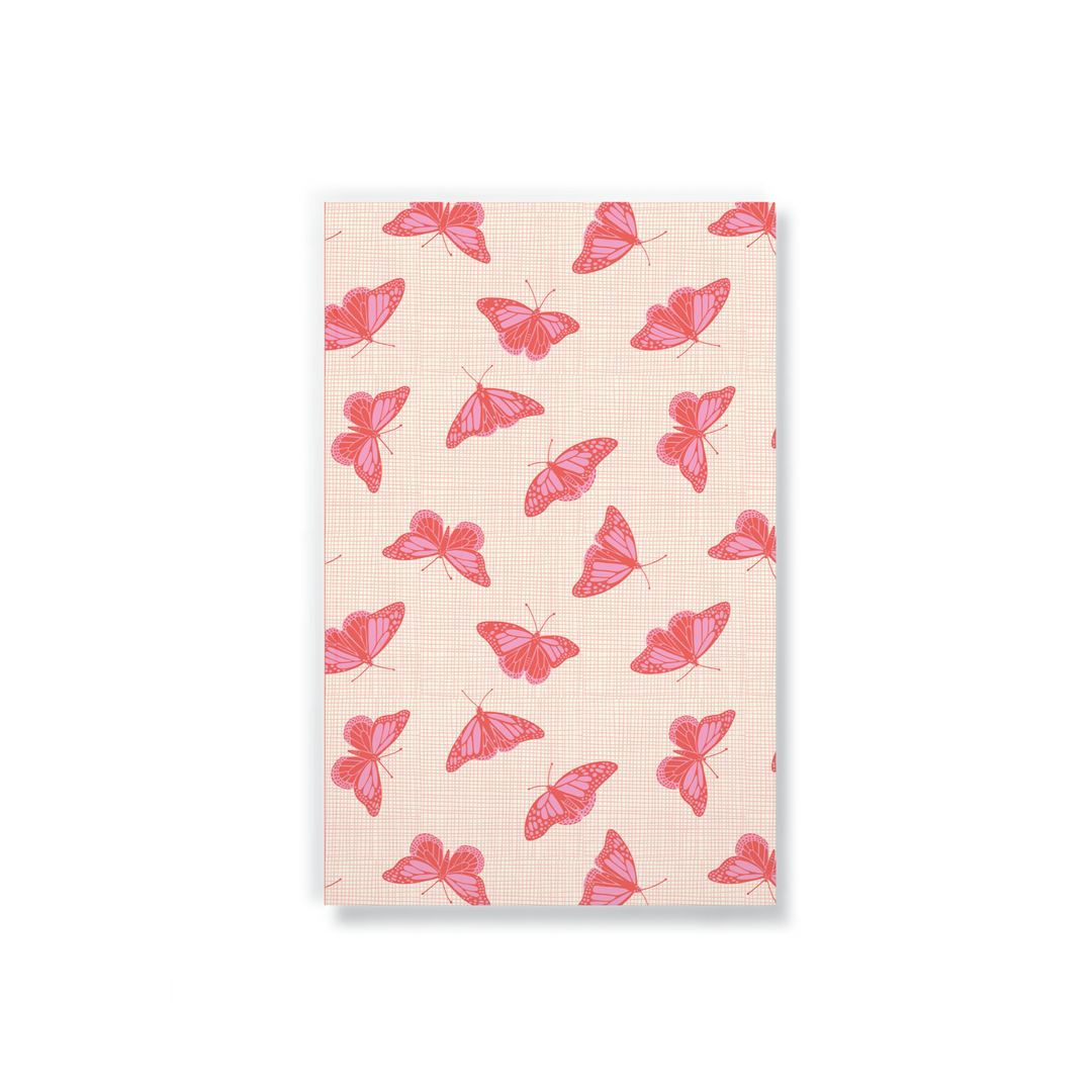 peach notebook with a blush colored butterfly pattern