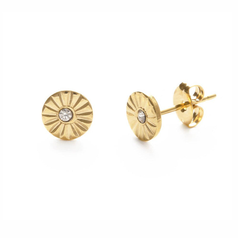 set of gold round stud earrings that feature a ripple design and a crystal in the center. Brand: Amano Studio
