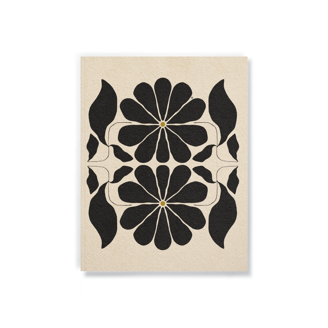 beige notebook with a black design of flowers in the center