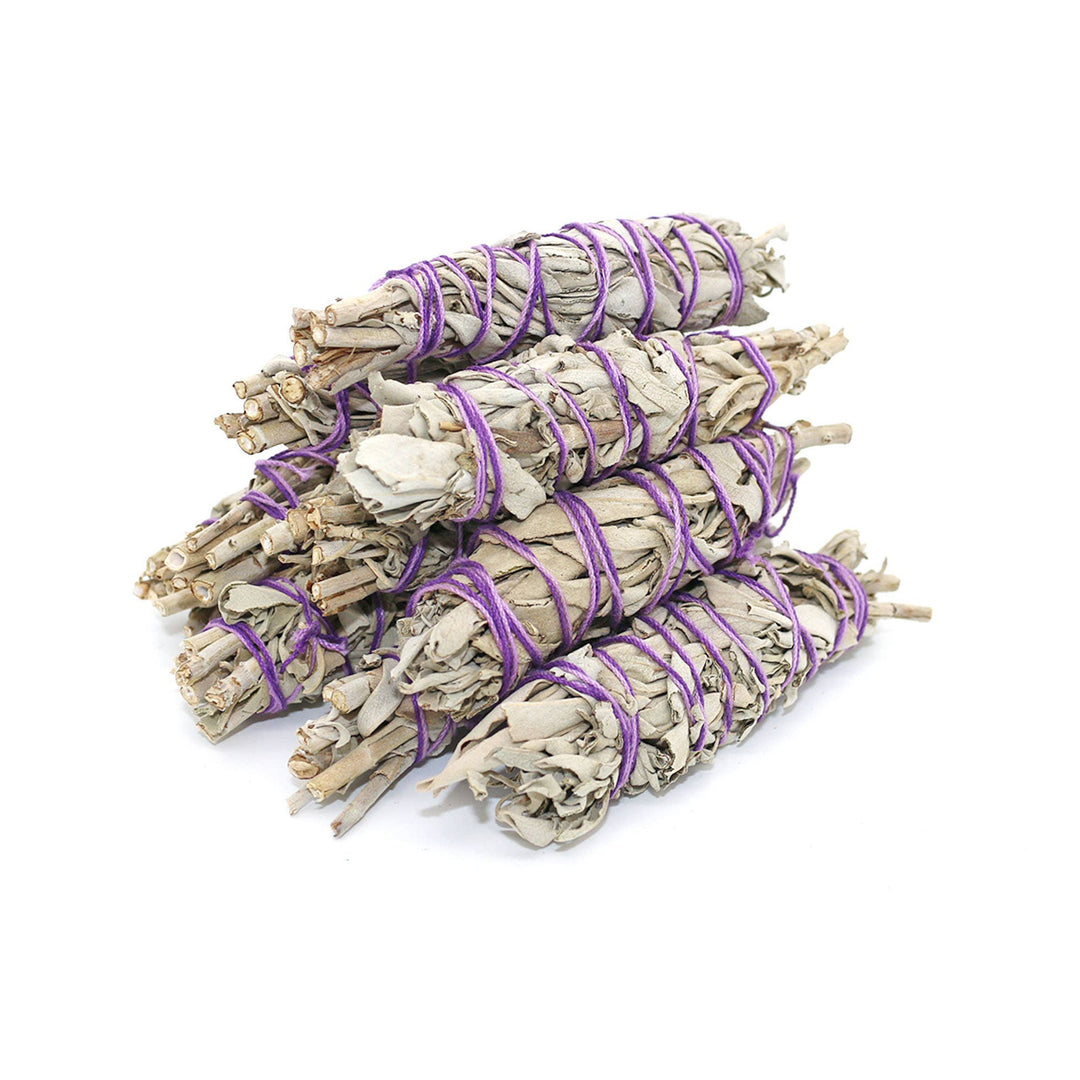 9 mini bundles of white sage tied with purple twine