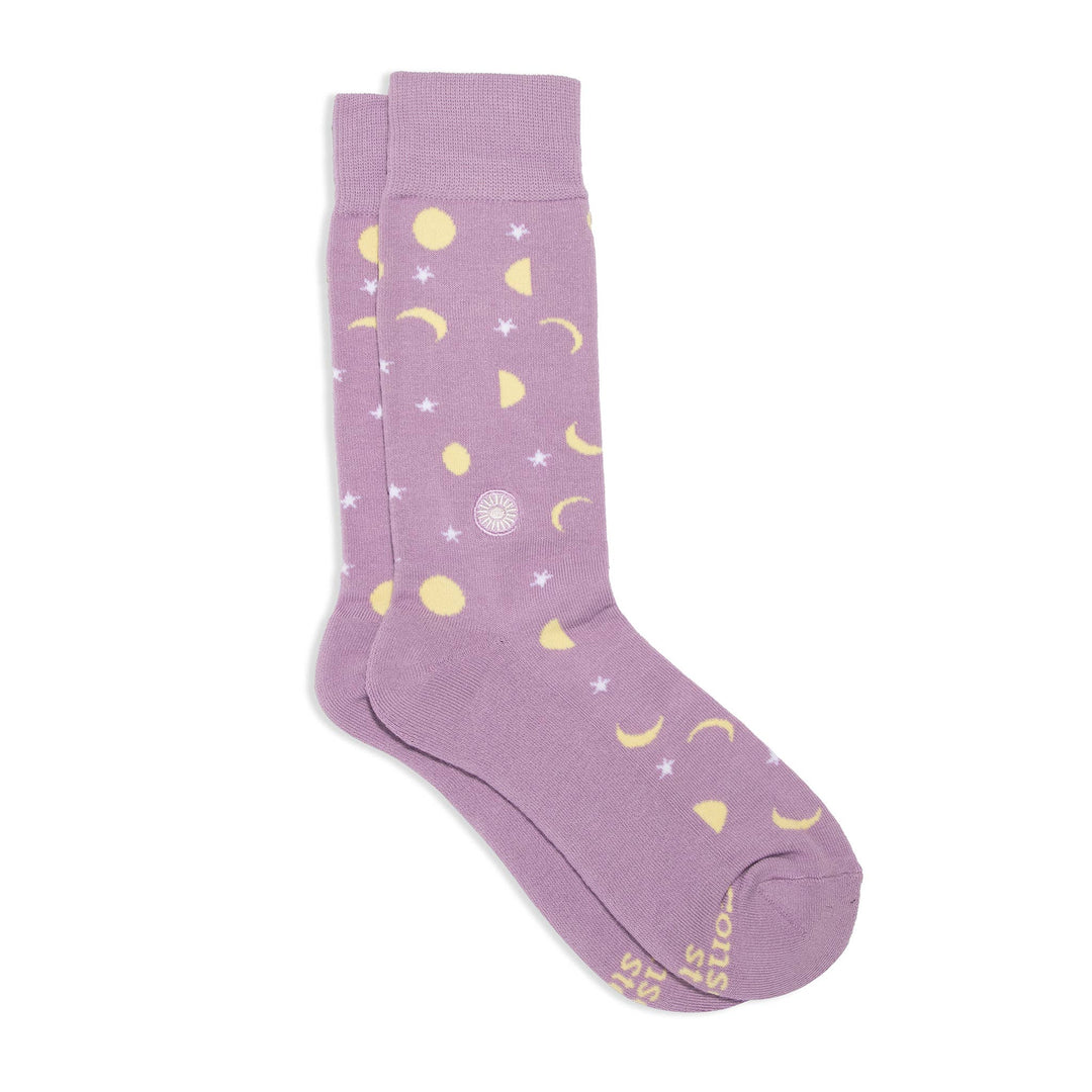 pair of purple socks with a celestial design in yellow and white.