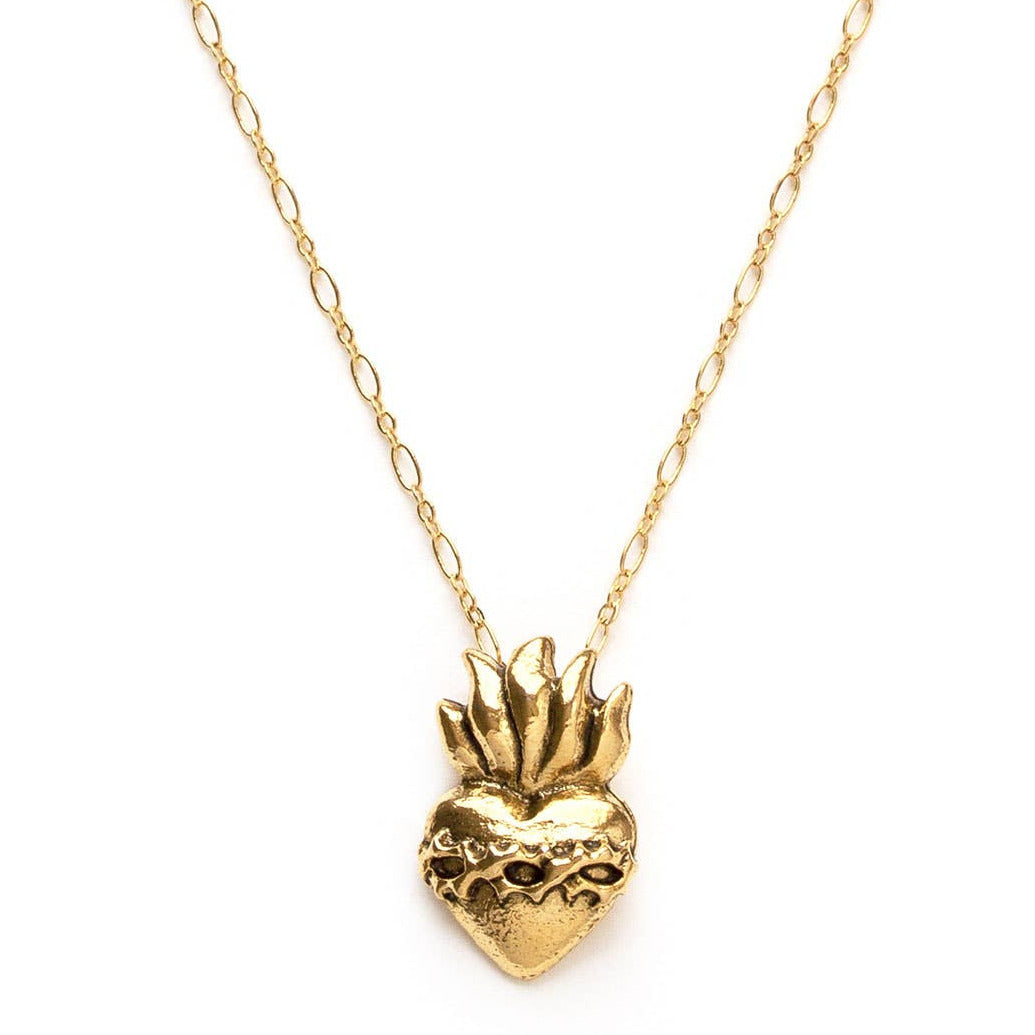 close up of a gold sacred heart pendant necklace with a gold chain. Brand: Amano Studio