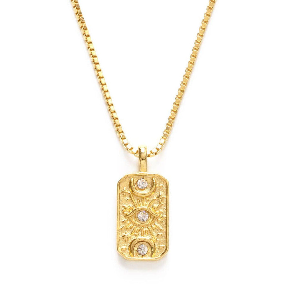Close up view of a rectangle medallion necklace featuring an eye and two crescent moons with 3 crystals. Brand: Amano Studio