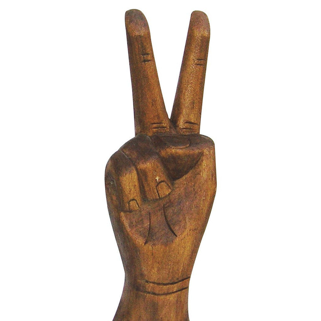 wooden sculpture of a hand in the peace sign position