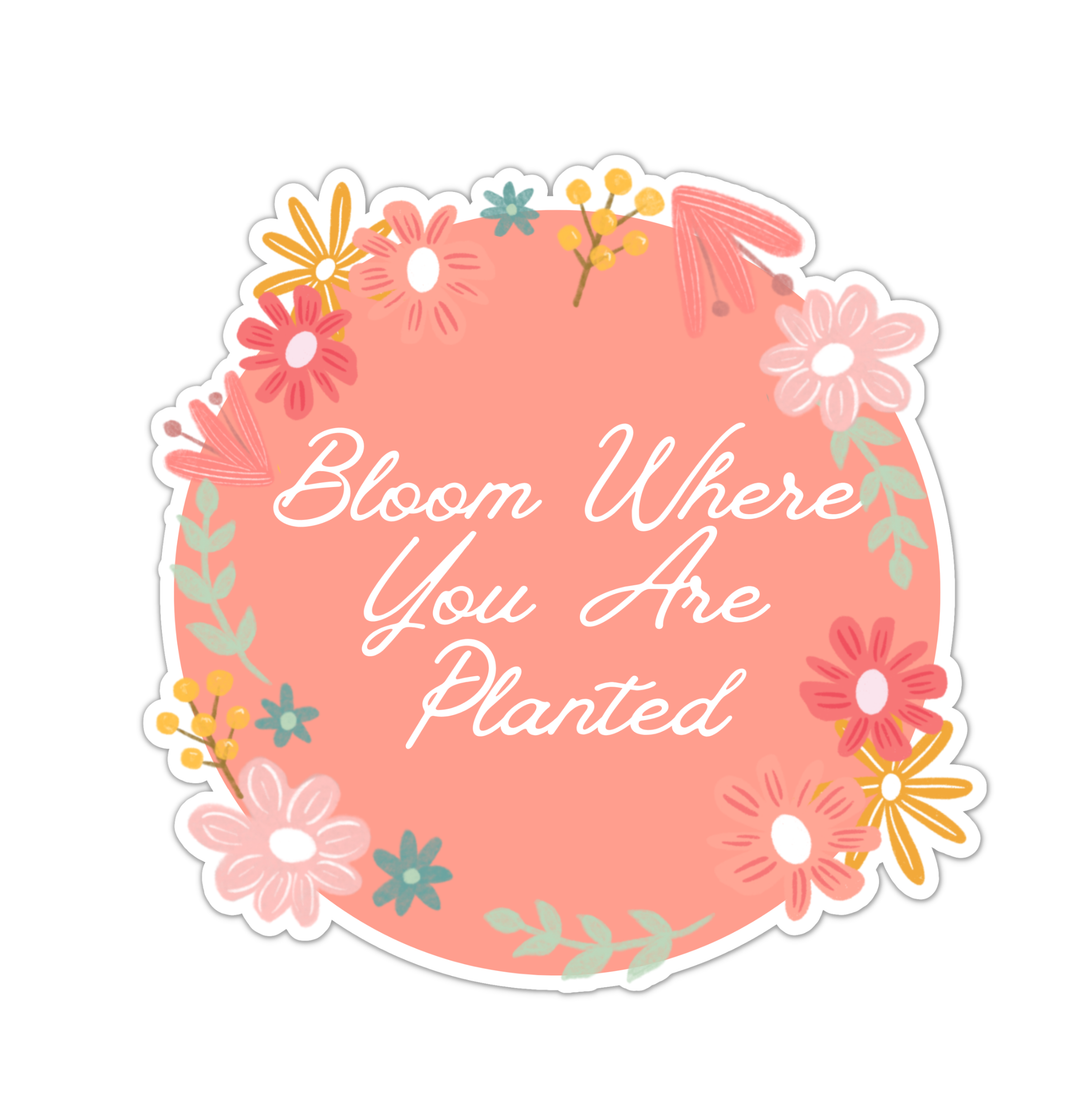 round coral sticker with flowers and featuring the phrase Bloom Where You Are Planted in white lettering