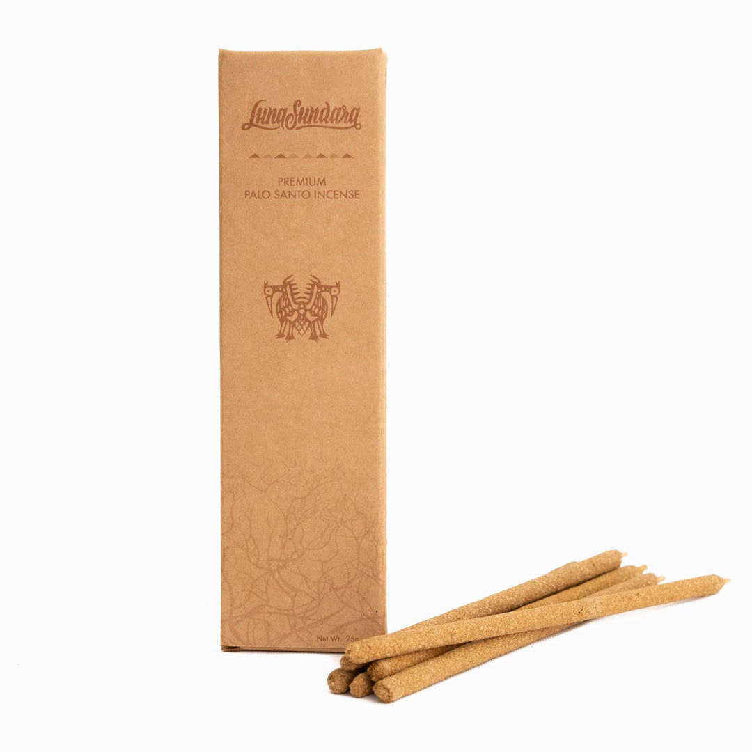 Six palo santo hand rolled incense sticks next to branded packaging. . Brand: Luna Sundara