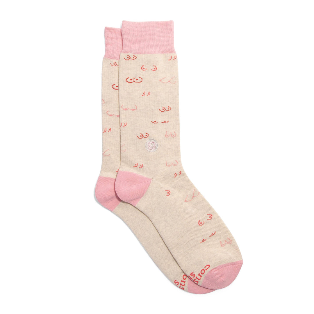 A pair of cream socks with a pink top band and versitile pairs of boobs.