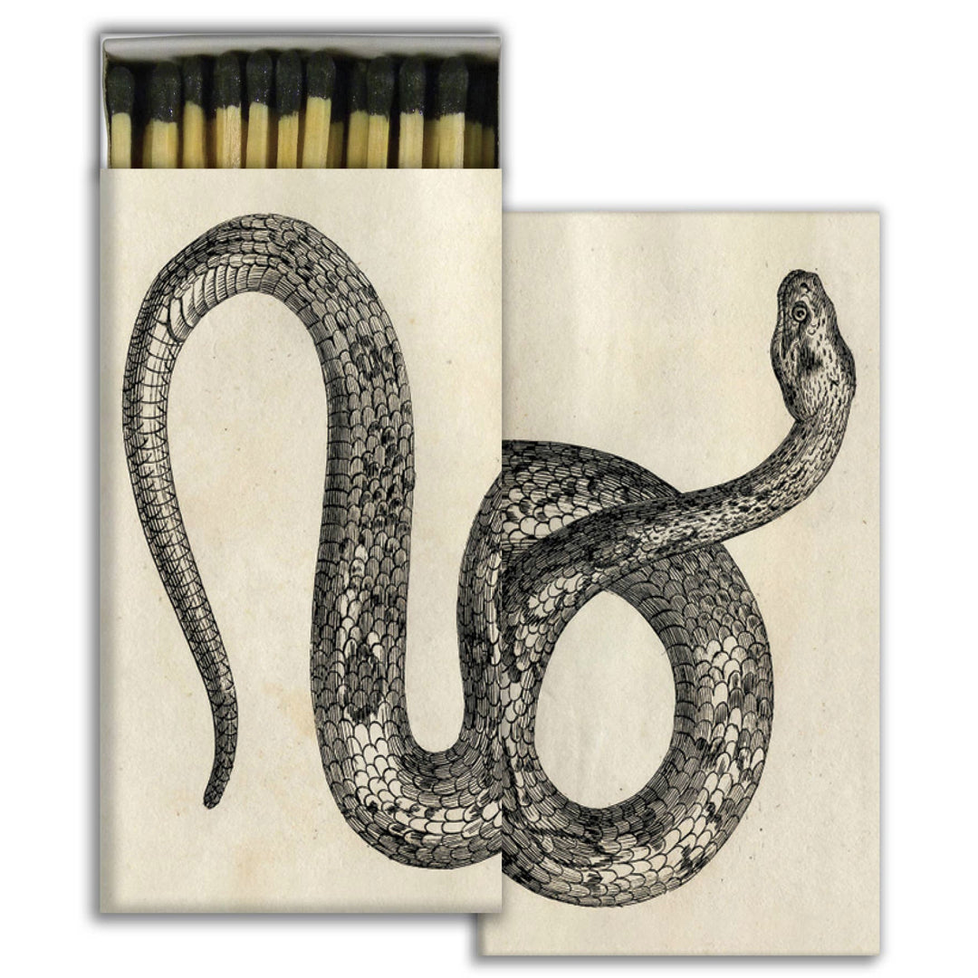 set of matches in off white boxes with an illustartion of a snake. one box is open with exposed matches.